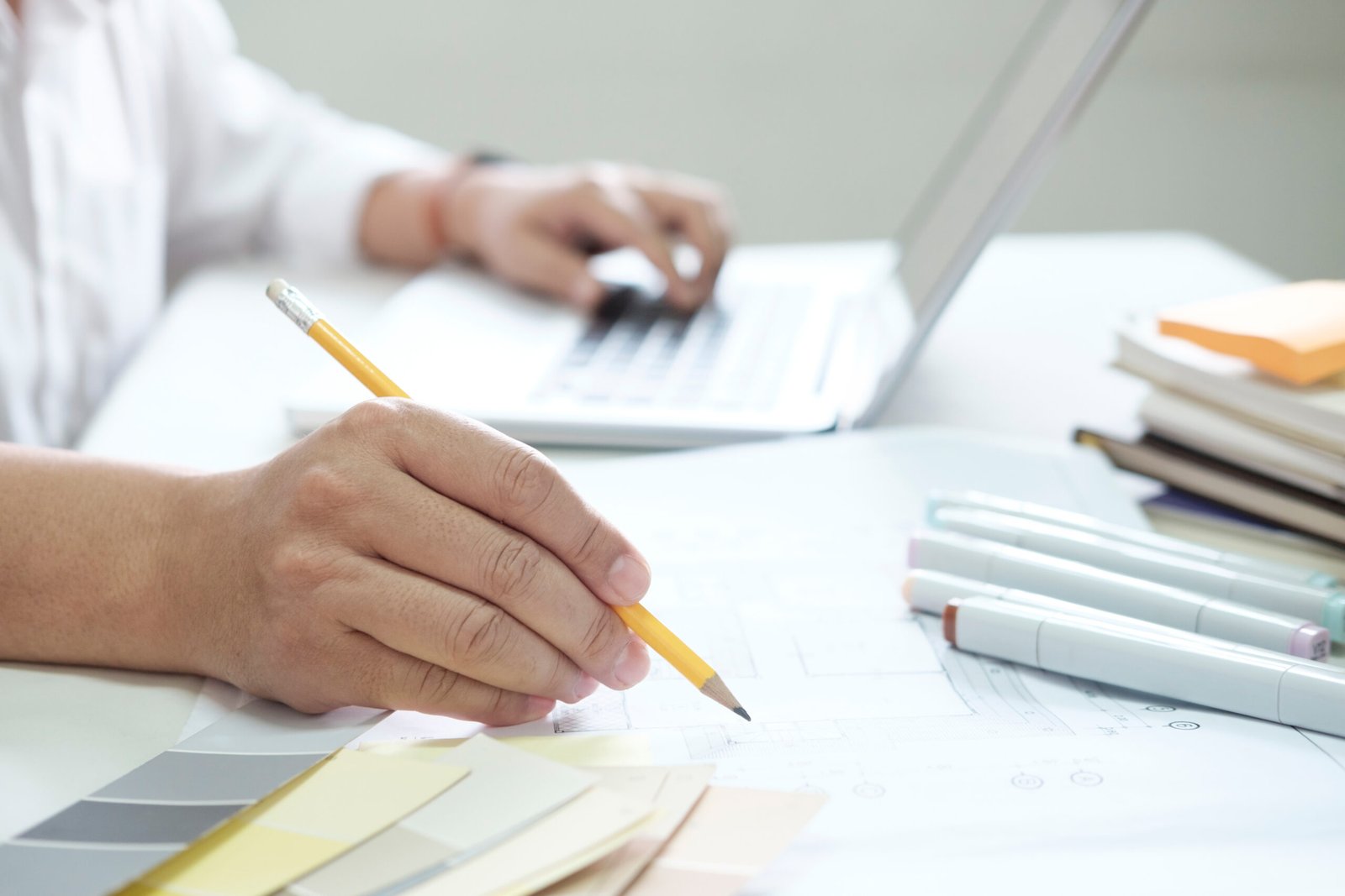 Graphic design and color swatches and pens on a desk. Architectu